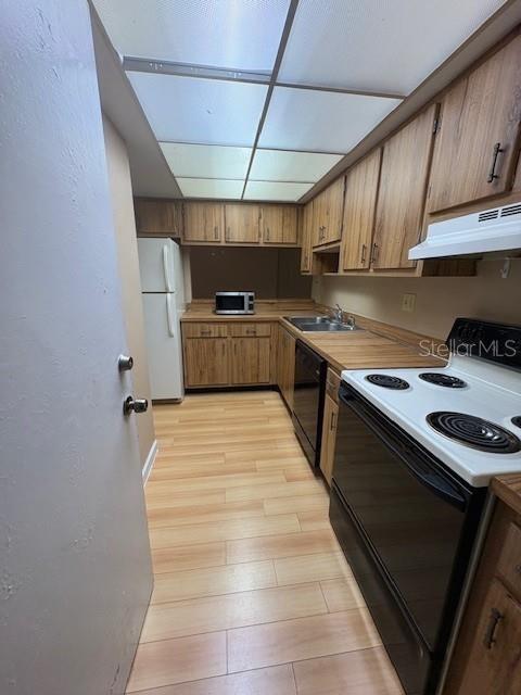 A view from a room looking through a pass-through window into a kitchen — 1839 BOUGH AVENUE UNIT B, CLEARWATER, FL