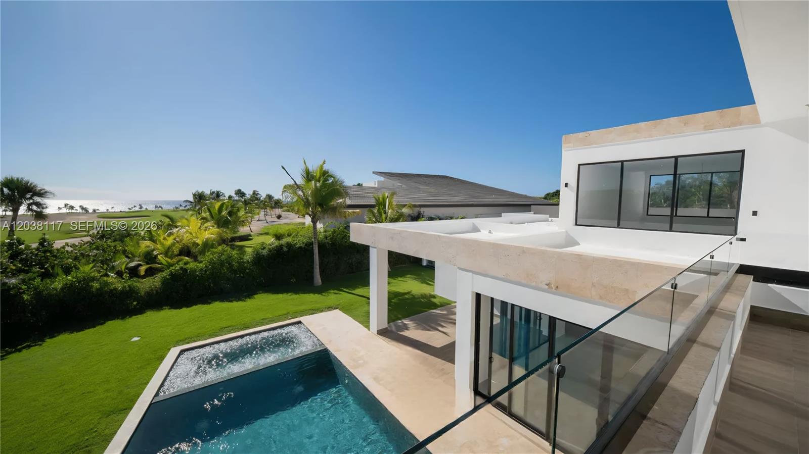 A modern house features a swimming pool, a glass balcony, and a view of the ocean — 0 sv las palmas, FL