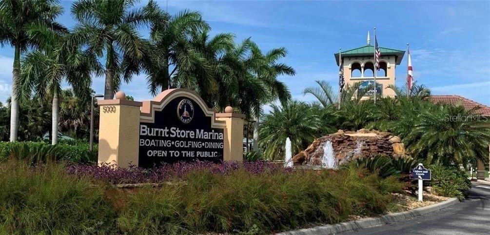 A sign for Burnt Store Marina stands in front of palm trees and a fountain — 4621 NW 36TH PLACE, CAPE CORAL, FL