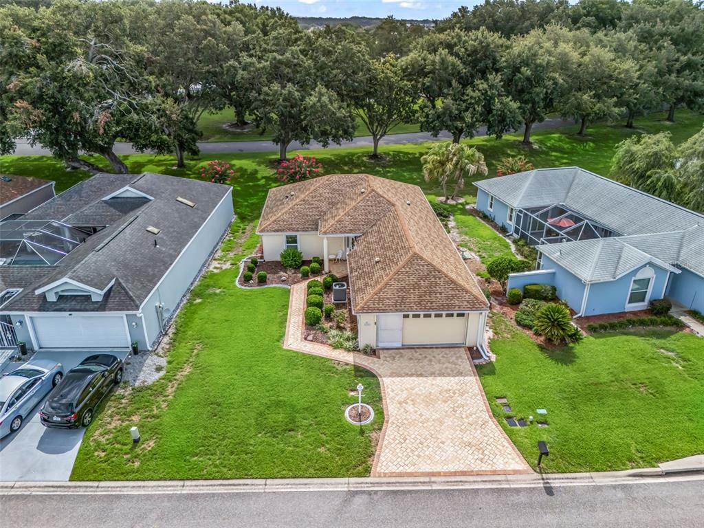 An aerial view shows a single-story house with a paved driveway and a landscaped yard — 17719 SE 114TH COURT, SUMMERFIELD, FL