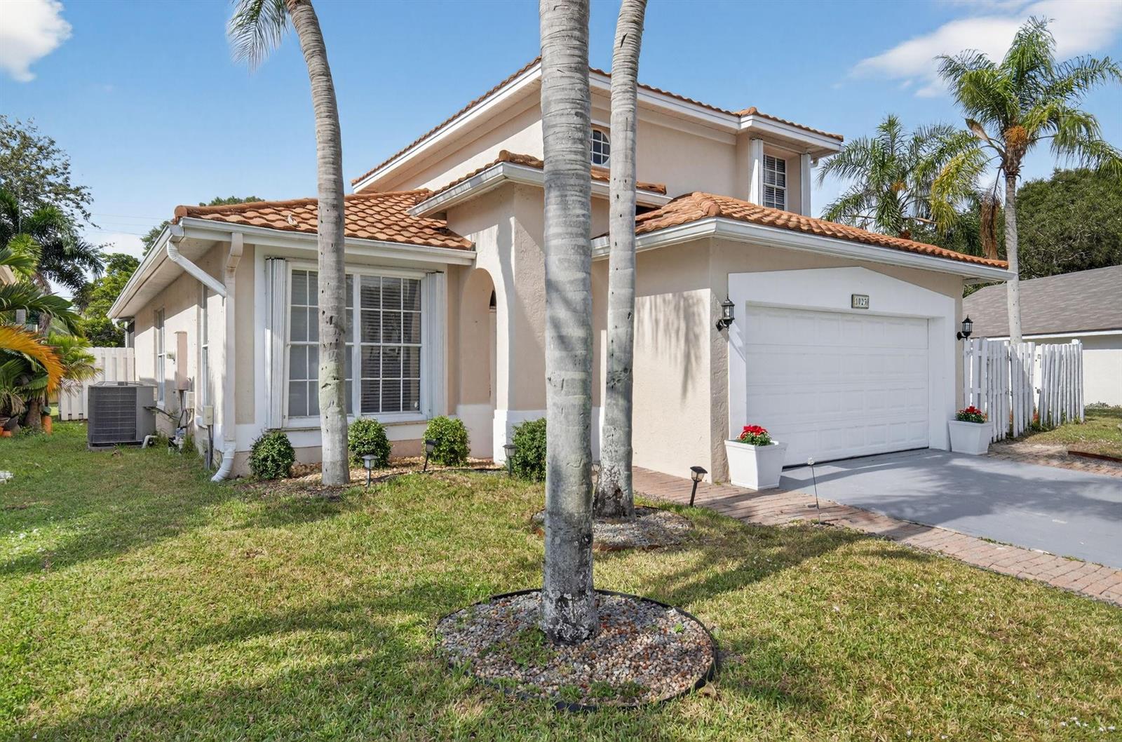 A two-story house with a tile roof, a garage, and palm trees in the front yard — 1023 Fairfax Circle, Boynton Beach FL 33436, BOYNTON BEACH, FL