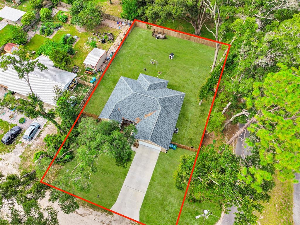 An aerial view shows a single-story house with a fenced backyard and a concrete driveway — 23781 NW 193RD AVENUE, HIGH SPRINGS, FL
