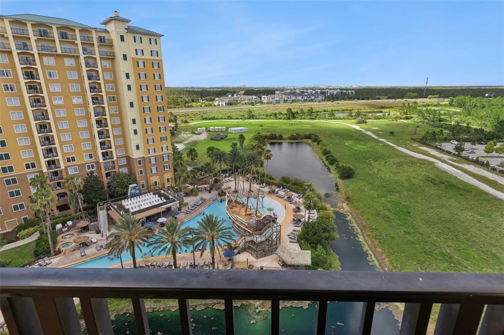 An elevated view shows a tall hotel building next to a pool with a pirate ship — 8101 RESORT VILLAGE DRIVE UNIT 31110, ORLANDO, FL