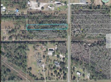 This aerial map shows a rectangular plot of land highlighted in blue along a road — 3332 BABBITT AVENUE, ORLANDO, FL