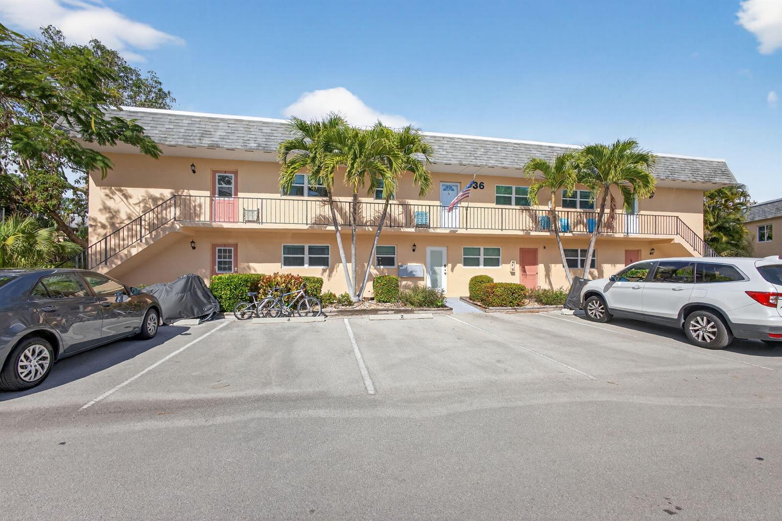 A two-story apartment building with a parking lot and palm trees in front — 2950 SE Ocean Blvd Boulevard, Stuart FL 34996, STUART, FL