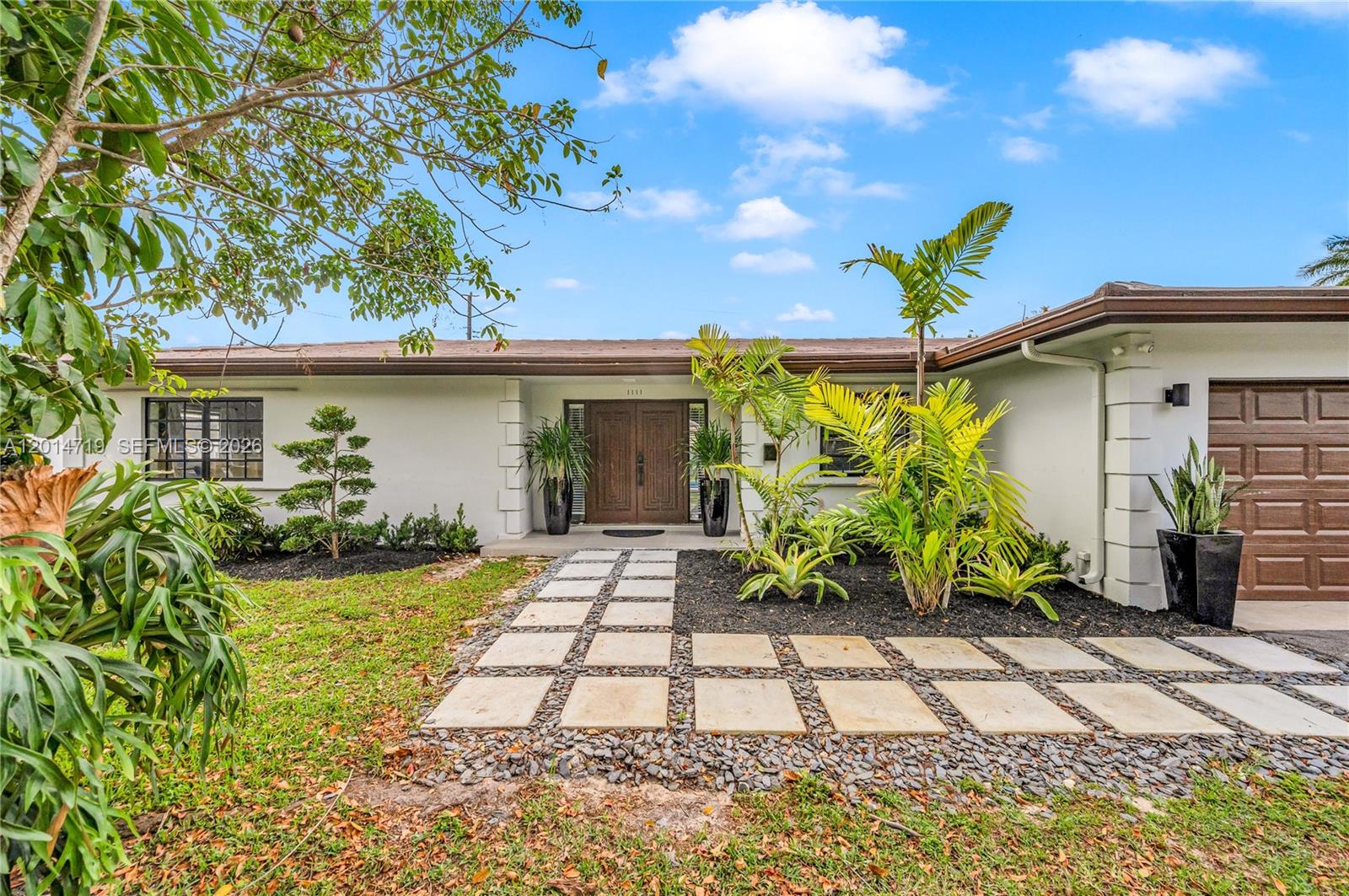 A single-story house features a paved walkway leading to double wooden front doors — 1111 NW 70th Ter, Plantation FL 33313, PLANTATION, FL