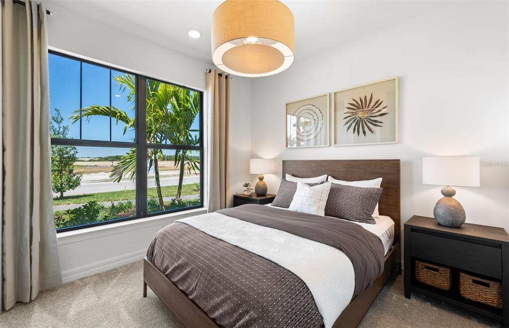 A bedroom features a queen bed, two nightstands, a large window, and a drum pendant light — 2712 WINDING CREEK TRAIL, NORTH PORT, FL