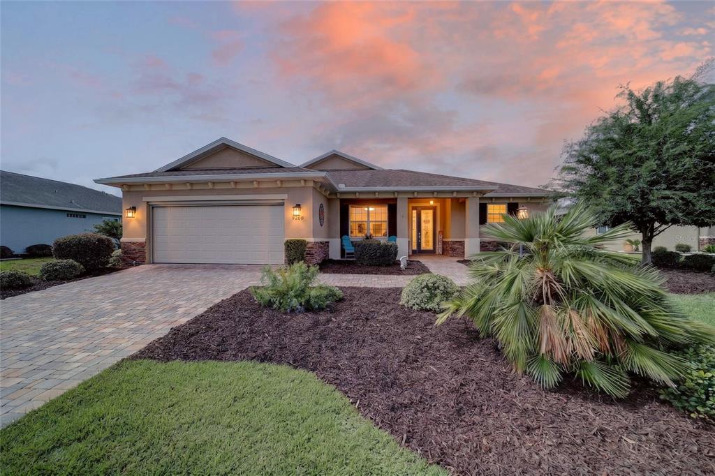 A single-story house with a paved driveway, stone accents, and a landscaped front yard — 9200 SW 85TH PLACE, OCALA, FL