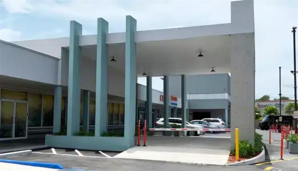 A modern commercial building exterior features a covered drive-through entrance with teal support columns — 3 PR-3 KM. 45.5, FAJARDO, PR