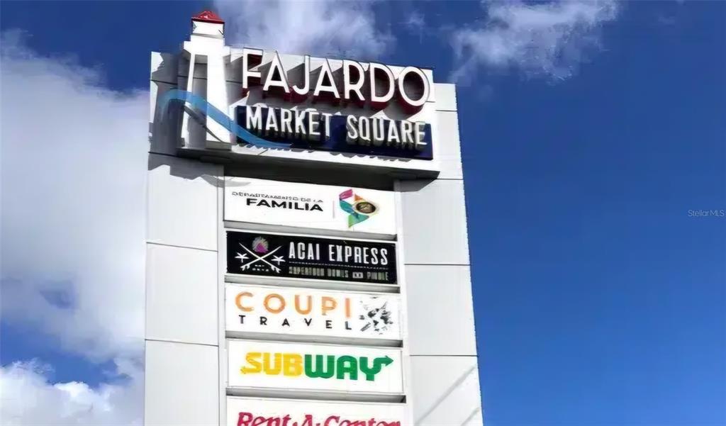 A tall, white pylon sign displays the name Fajardo Market Square and several tenant logos — 3 PR-3 KM. 45.5, FAJARDO, PR