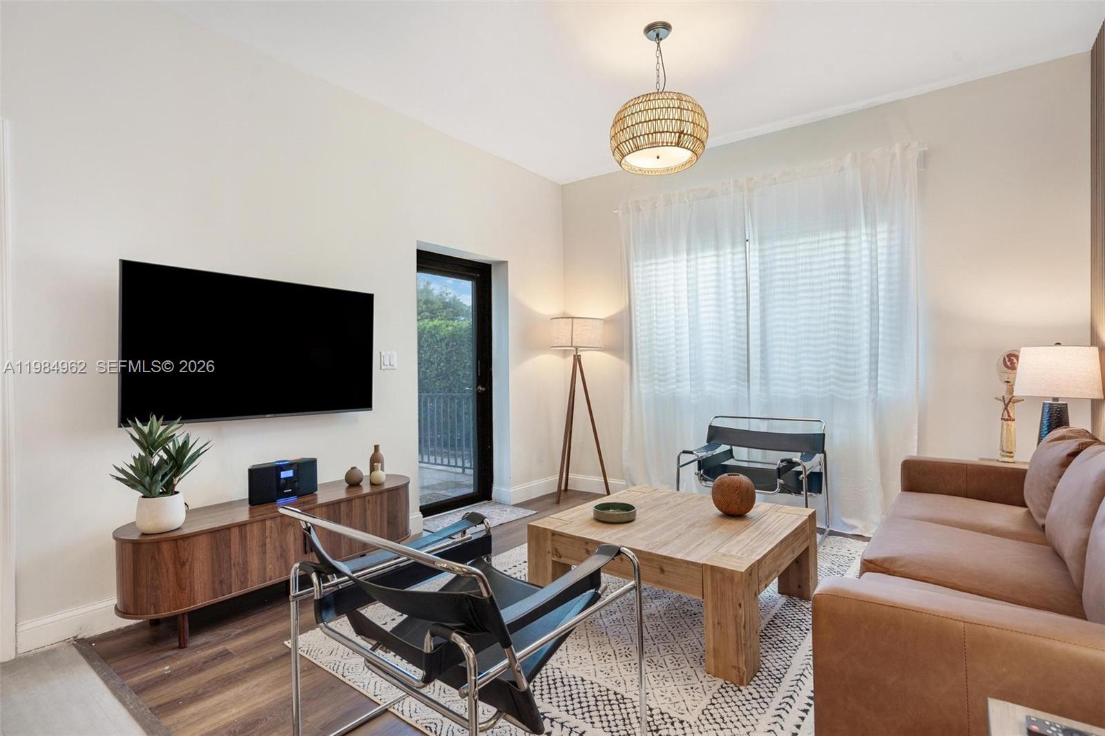 A living room features a leather sofa, two black chairs, and a wooden coffee table — 920 SW 9th St, Miami FL 33130, MIAMI, FL