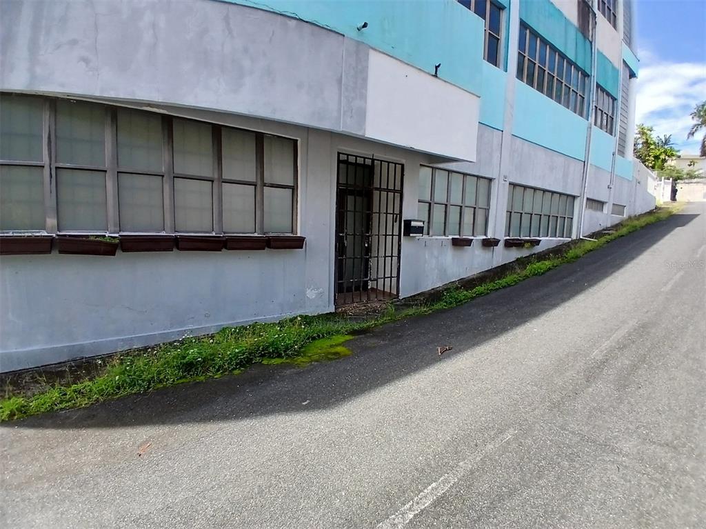 A gray building exterior features a metal-grated doorway and rows of windows with planter boxes — 97 STATE ROAD 2 PUEBLO VIEJO, GUAYNABO, PR