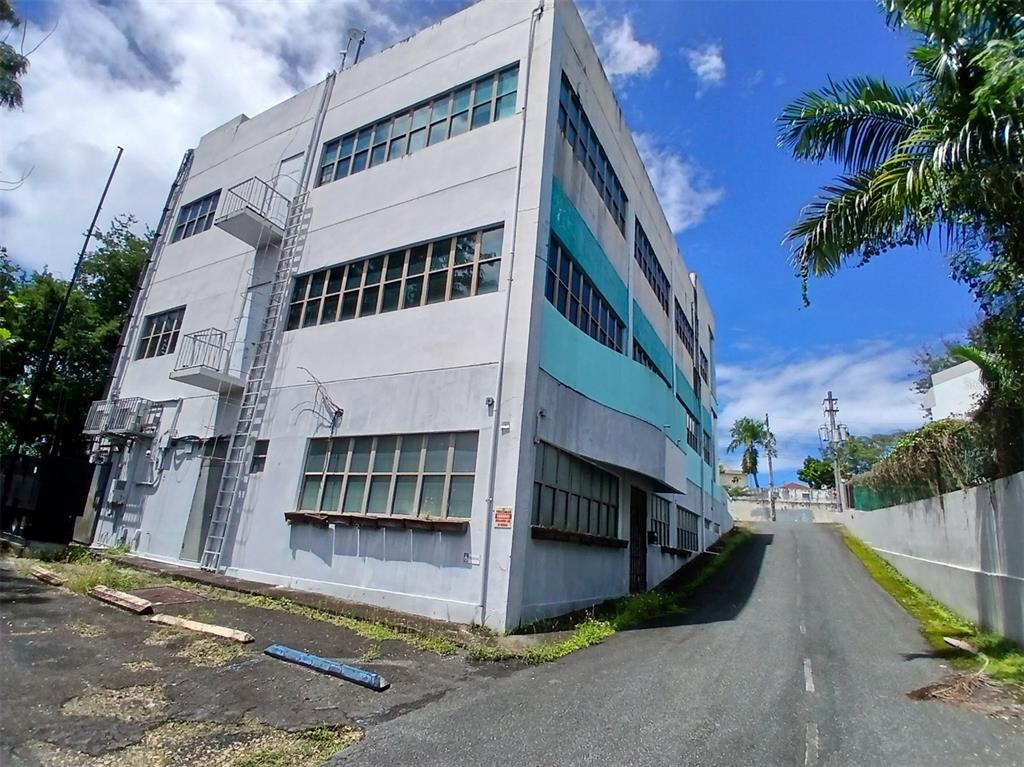 A multi-story industrial building with a metal fire escape and a paved driveway alongside — 97 STATE ROAD 2 PUEBLO VIEJO, GUAYNABO, PR