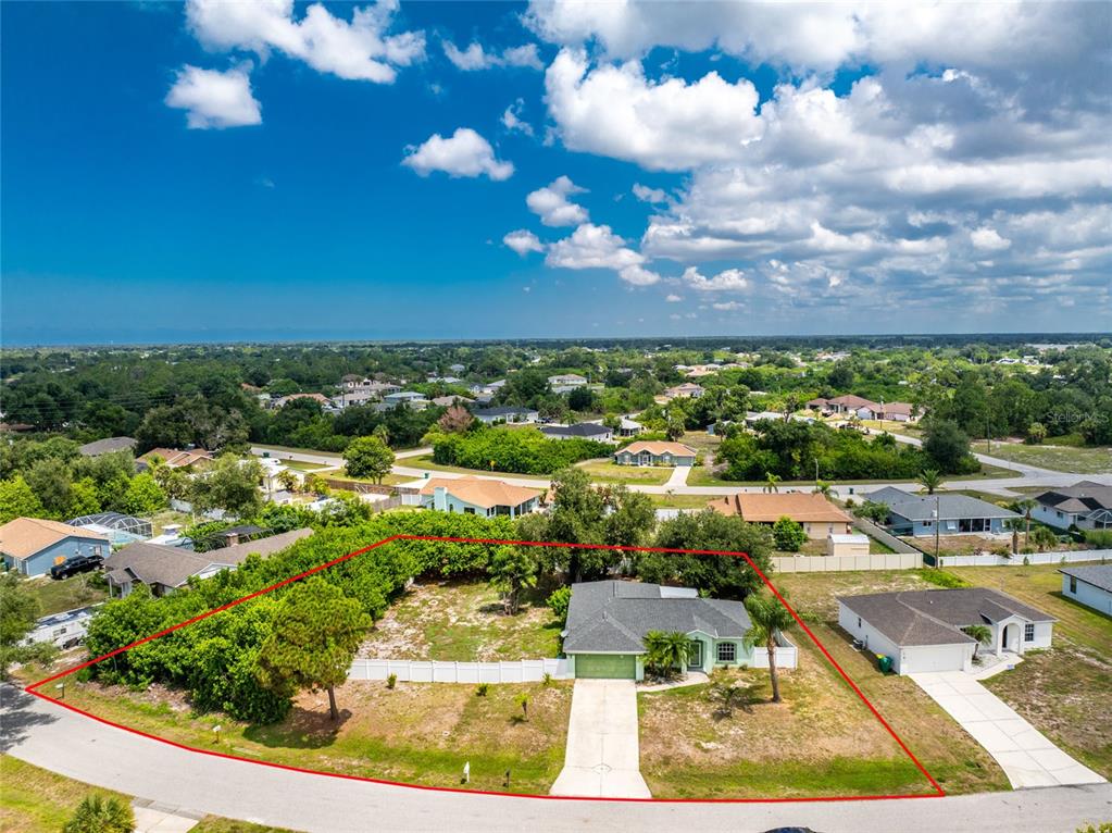 An aerial view shows a single-story house with a large yard outlined in red — 11082 VANESSA AVENUE, ENGLEWOOD, FL