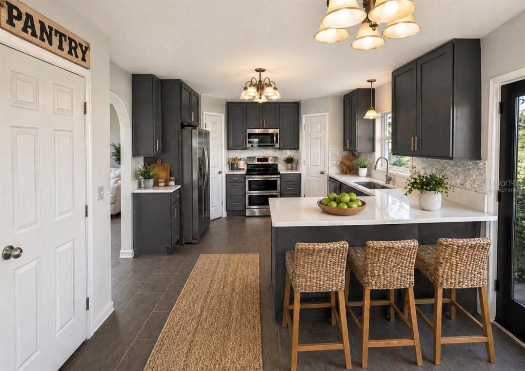 A staircase with gray treads and patterned risers leads to an upper landing with two doors — 239 CURTIS AVENUE, GROVELAND, FL