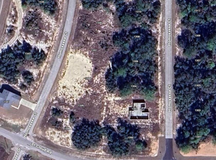 This aerial map shows several vacant lots and one building foundation on a residential street — 1342 HOMOSASSA COURT, POINCIANA, FL