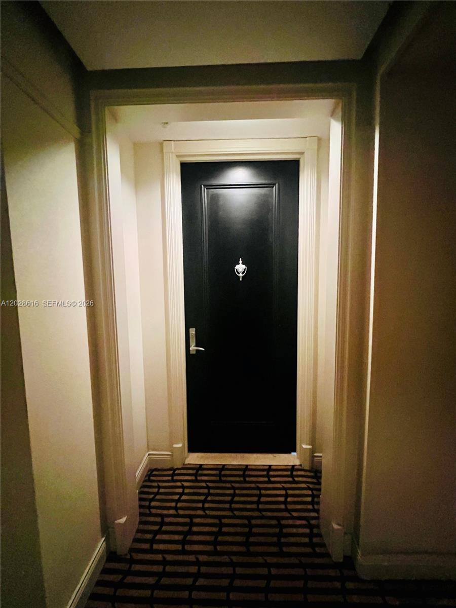 A black door with a silver knocker is centered at the end of a hallway — 801 Brickell Key Blvd # 906, Miami FL 33131, MIAMI, FL