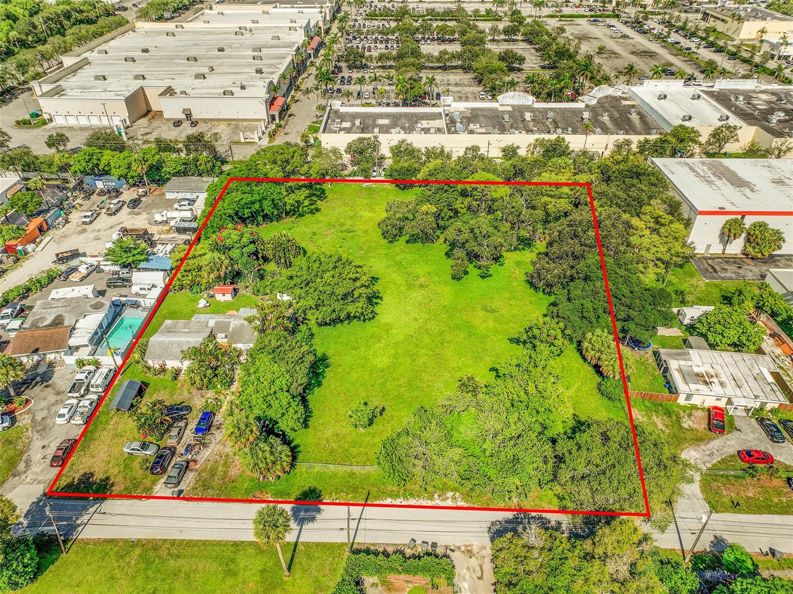 An aerial view shows a large, rectangular vacant lot outlined in red with surrounding buildings — 1865 Donnell Road, West Palm Beach FL 33409, WEST PALM BEACH, FL