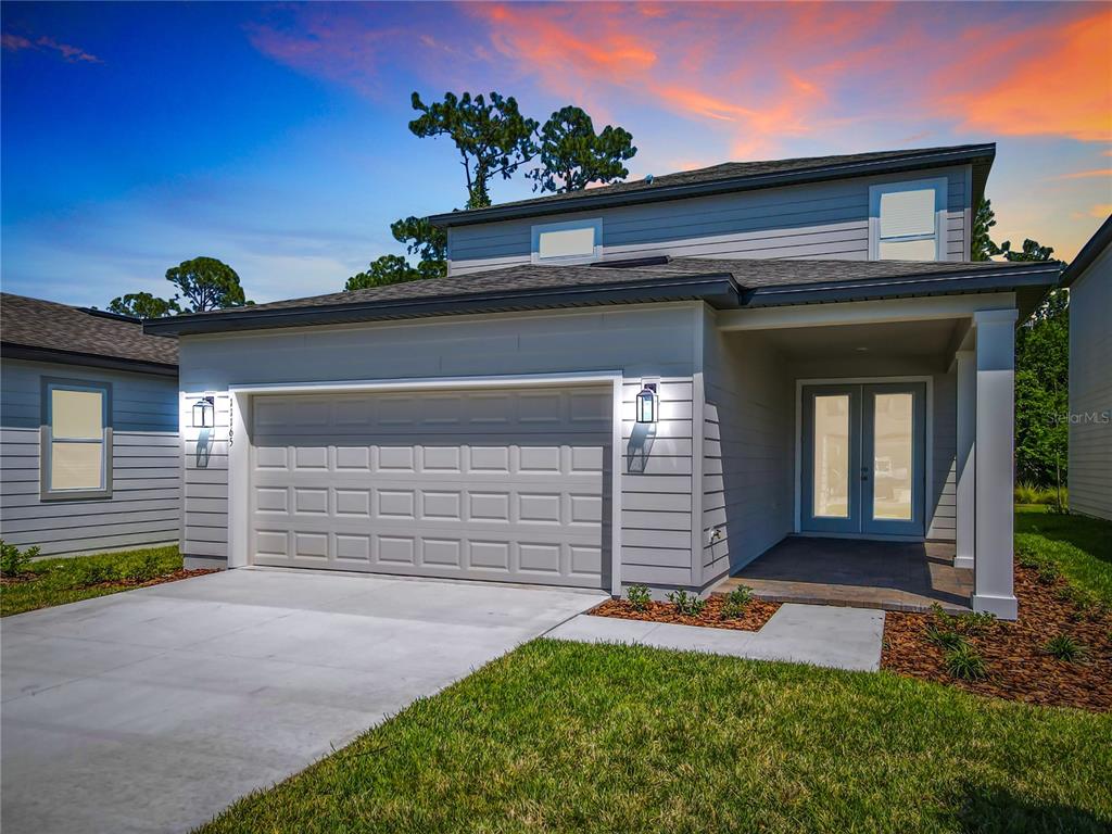 A two-story light gray house with a front porch, a bench, and a trash can — 11165 GREEN CITRON ALLEY, WINTER GARDEN, FL