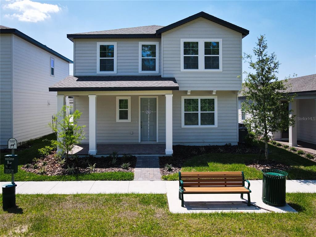 A two-story house with a gray exterior, a two-car garage, and a covered front entryway — 11165 GREEN CITRON ALLEY, WINTER GARDEN, FL