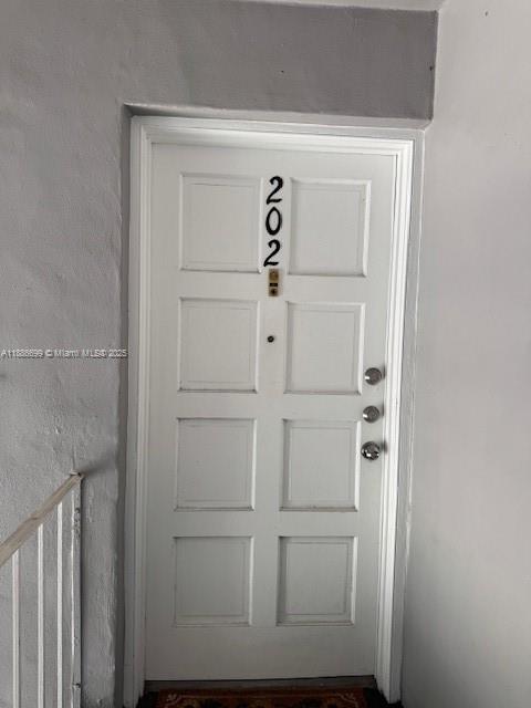 A white door labeled with the number 202 is set within a plain wall — 360 NW 69th Ave # 202, Plantation FL 33317, PLANTATION, FL