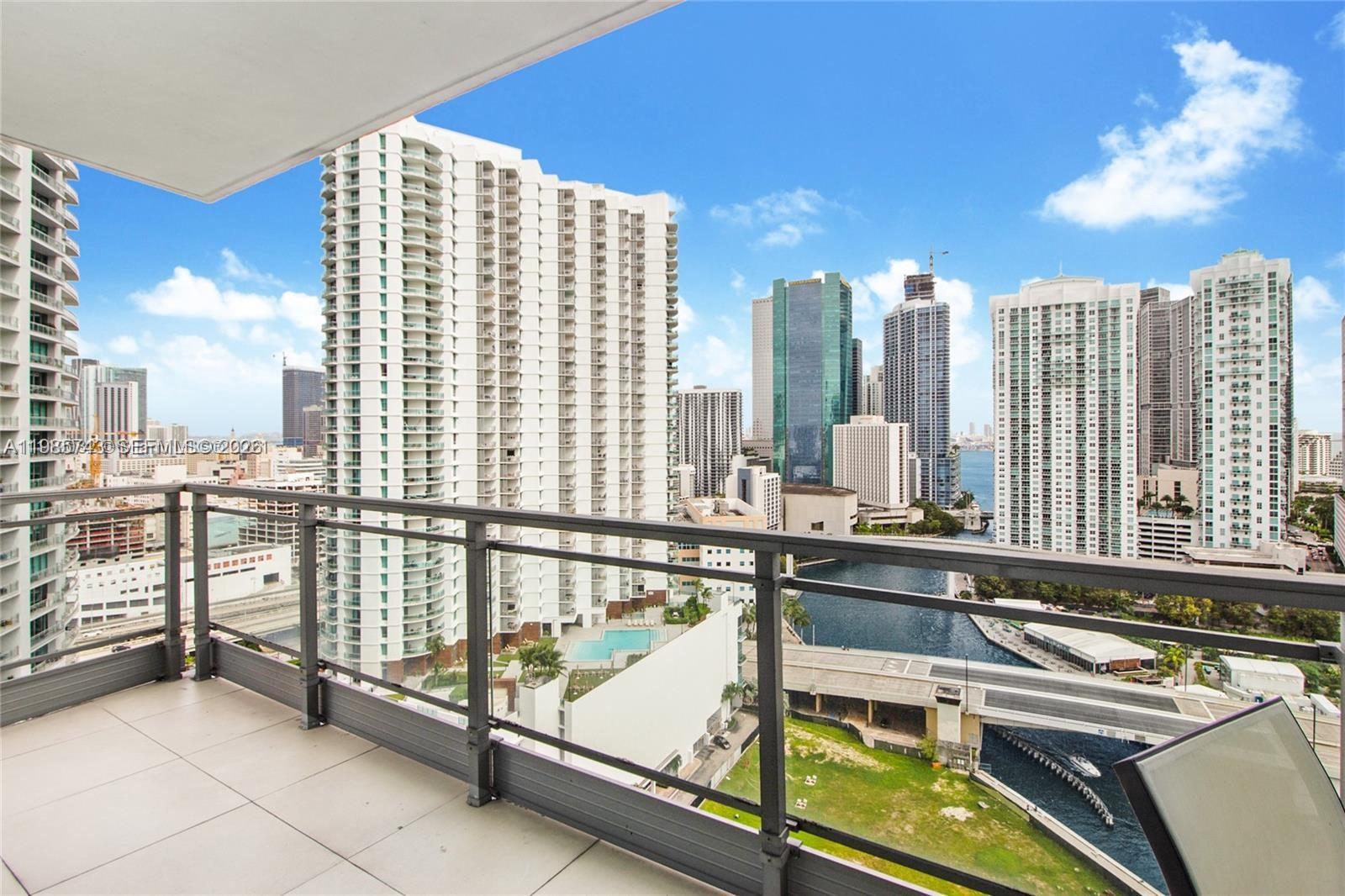 A balcony overlooks a city skyline, a river, and several high-rise residential buildings — 92 SW 3rd St # 2510, Miami FL 33130, MIAMI, FL