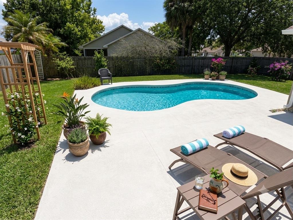 An aerial view of a house with a backyard swimming pool and a fenced lawn — 2406 ABALONE BOULEVARD, ORLANDO, FL
