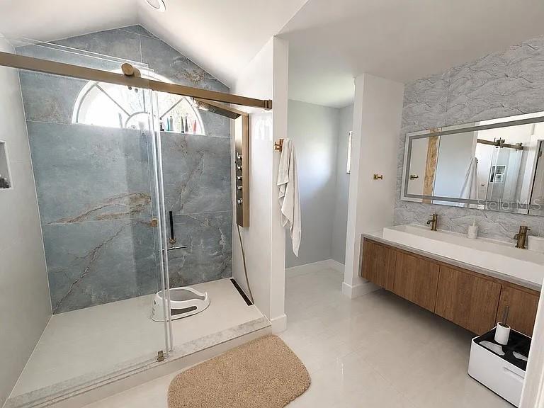 An entryway with tile flooring leads to a living area with a wooden front door — 2406 ABALONE BOULEVARD, ORLANDO, FL