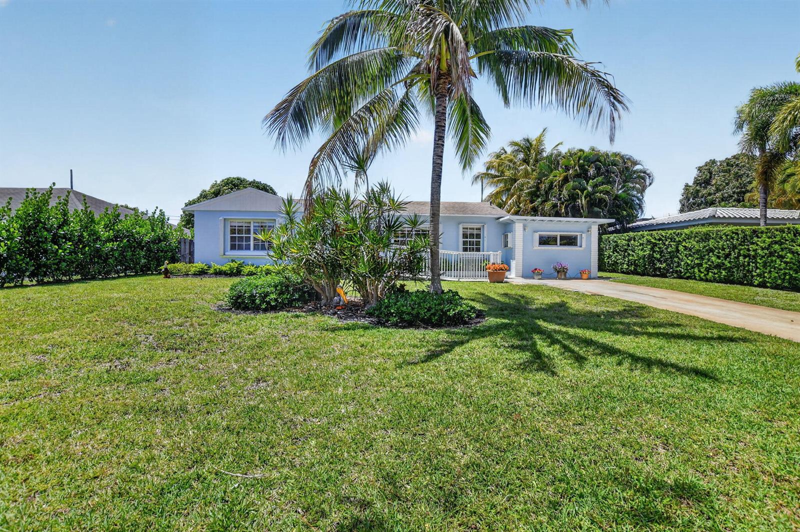 A light blue single-story house features a palm tree, a front lawn, and a driveway — 277 NW 3rd Court, Boca Raton FL 33432, BOCA RATON, FL