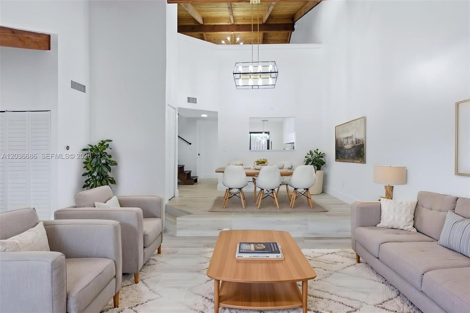 A living room and dining area feature vaulted wood-beam ceilings and light-colored tile floors — 2152 SW 81st Way, Davie FL 33324, DAVIE, FL