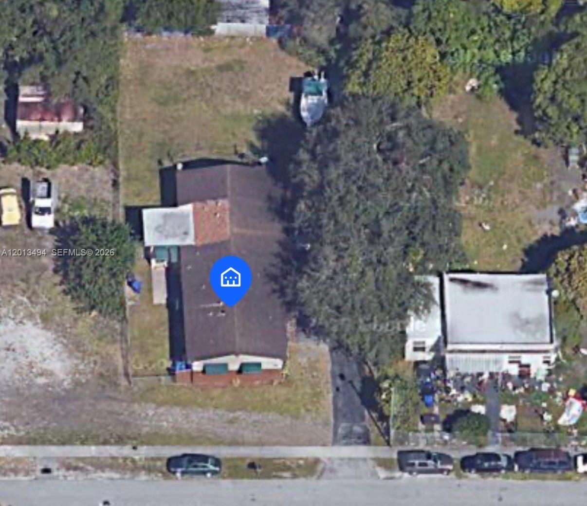 An aerial view shows a single-story house with a driveway and a large backyard tree — 5631 SW 27th St, West Park FL 33023, WEST PARK, FL