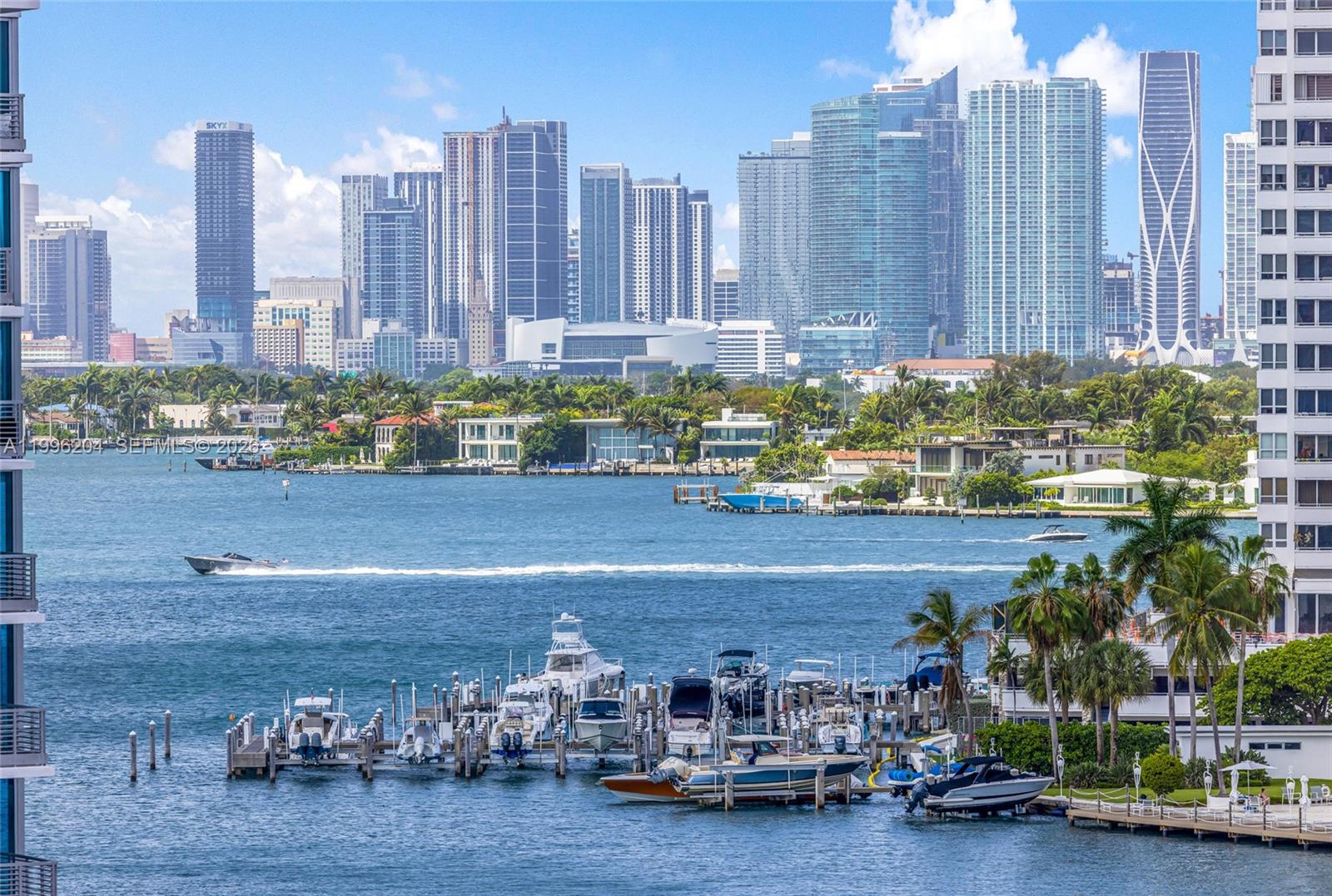 A high-angle view shows a marina with docked boats in front of a Miami skyline — 1621 Bay Rd # 802, Miami Beach FL 33139, MIAMI BEACH, FL