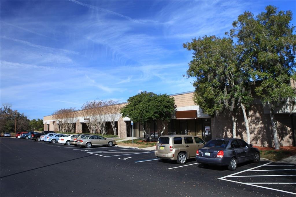 A single-story commercial building with a parking lot in front under a blue sky — 3300 SW 34TH AVENUE UNIT 103, OCALA, FL