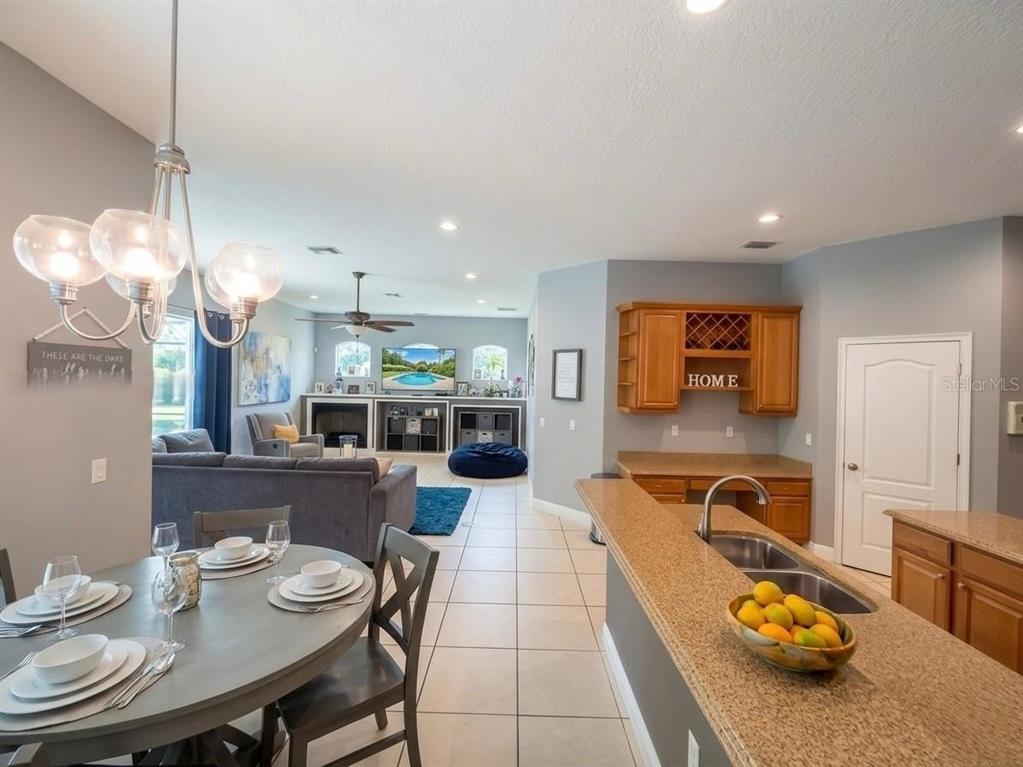 A single-story house with a stone facade, a paved driveway, and a large front lawn — 330 GLEN CLUB DRIVE, DEBARY, FL