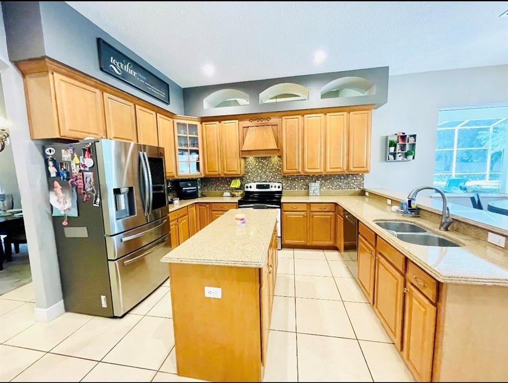 A single-story house with a stone facade, a paved driveway, and a manicured lawn — 330 GLEN CLUB DRIVE, DEBARY, FL