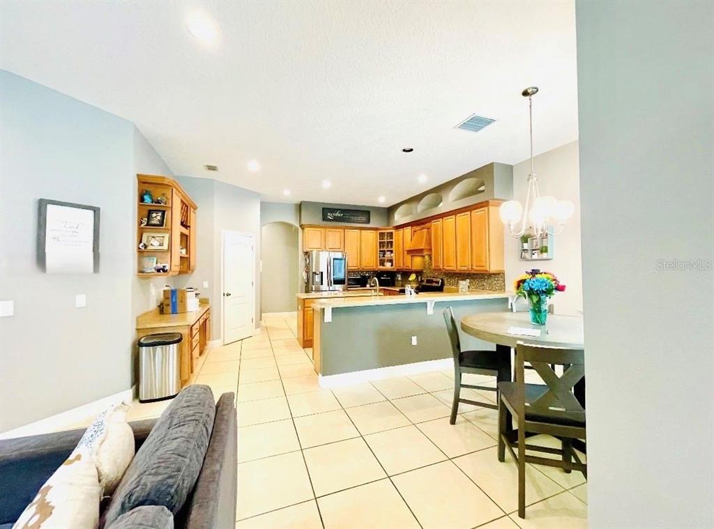 A single-story house with a stone facade, arched entryway, and a paved driveway — 330 GLEN CLUB DRIVE, DEBARY, FL