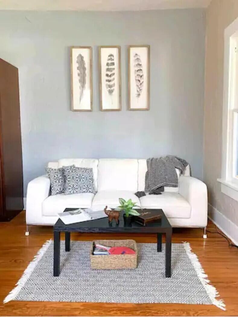 A living room features a white sofa, a black coffee table, and three framed prints — 711 S N Street # 1, FL 33460, FL