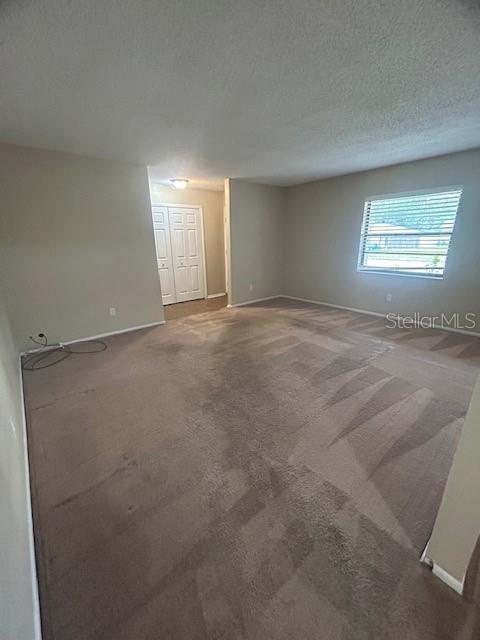 An empty room with beige carpet, light-colored walls, and a white double-door closet — 1509 CARDINAL STREET, LONGWOOD, FL