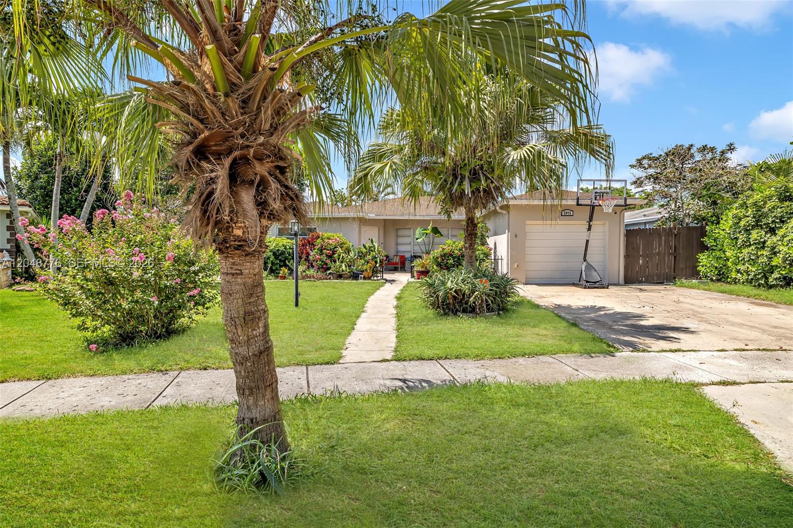 A single-story house features a front lawn, a concrete driveway, and two large palm trees — 5045 SW 10th St, Margate FL 33068, MARGATE, FL