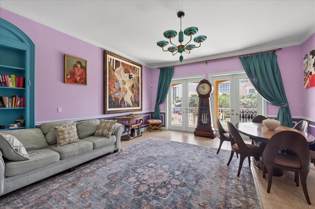 A living and dining room with lavender walls, a large rug, and a grandfather clock — 120 AVENUE DE LA MER UNIT 1502, PALM COAST, FL
