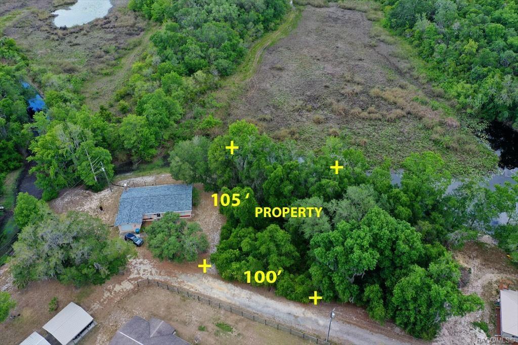 An aerial view shows a wooded lot with a house and road frontage — 6979 E GRASS COURT, INVERNESS, FL