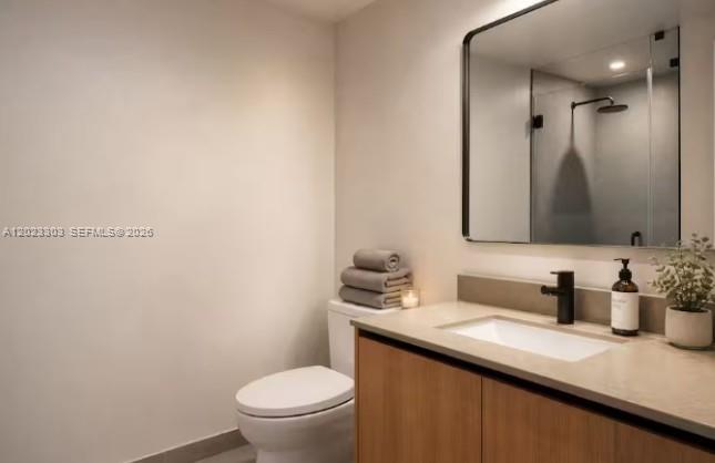 A modern bathroom features a wood vanity, a white countertop, and a wall-mounted mirror — 121 NE 5th St # 3203, Miami FL 33132, MIAMI, FL