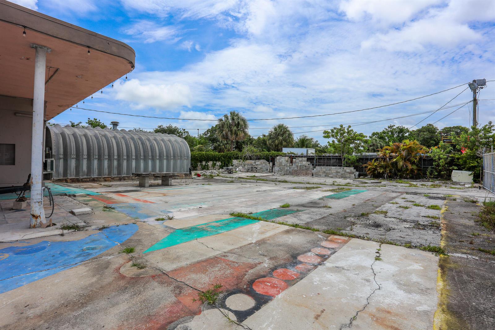An outdoor paved area with painted patterns, a metal Quonset hut, and a covered patio — 1620 S Dixie Highway, Pompano Beach FL 33060, POMPANO BEACH, FL