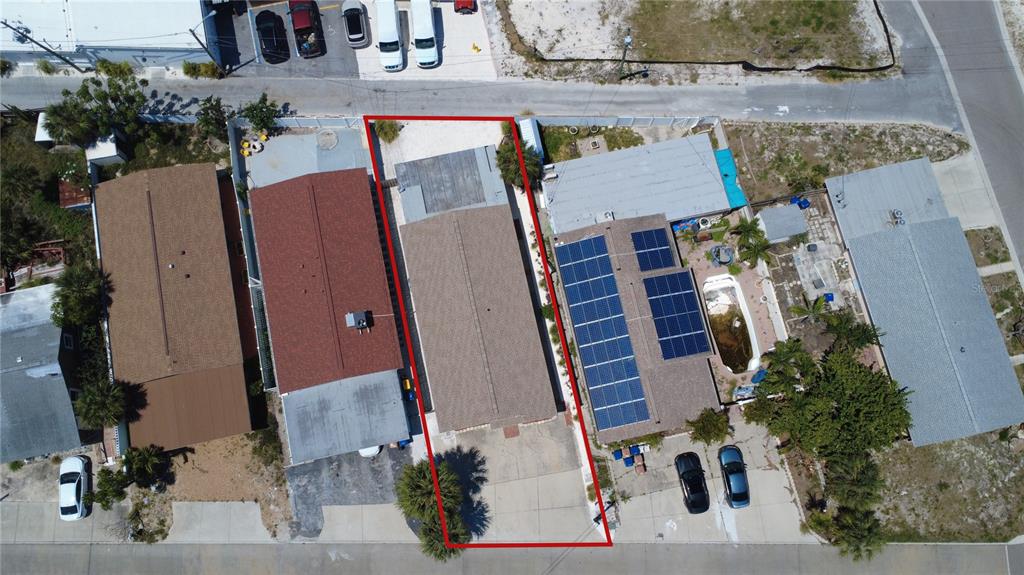 An aerial view shows a rectangular residential property outlined in red between two neighboring houses — 13440 1ST STREET E, MADEIRA BEACH, FL