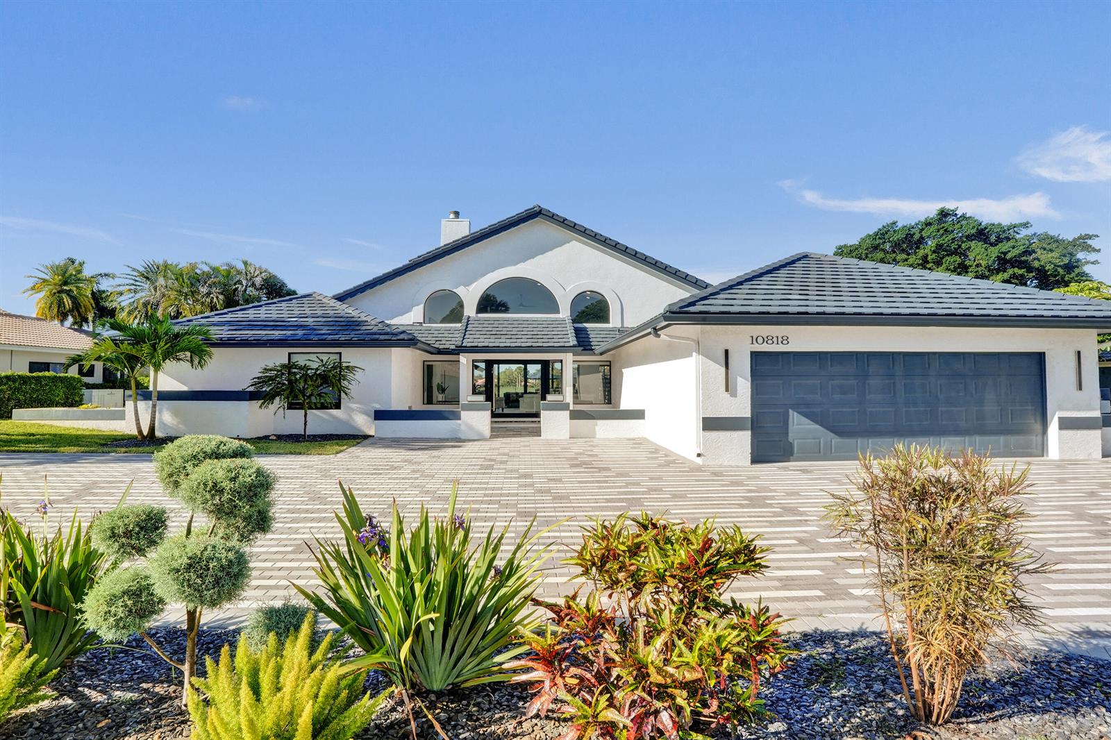 A white single-story house with a dark tiled roof and a large paved driveway — 10818 River Glenn Drive, Boca Raton FL 33428, BOCA RATON, FL
