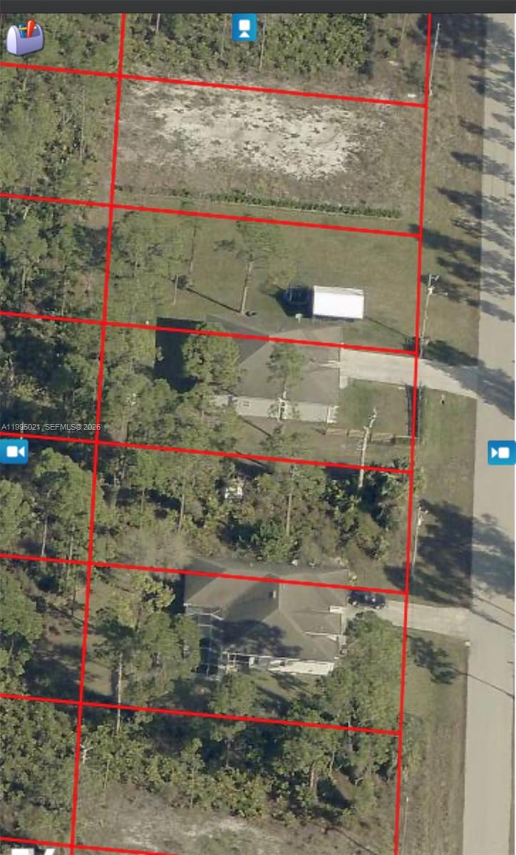 This aerial map shows several residential lots with houses and wooded areas along a road — 858 Babbit Ave, Lehigh Acres FL 33974, LEHIGH ACRES, FL