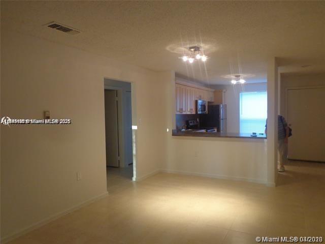 A living area opens to a kitchen with light-colored cabinets and a breakfast bar — 2276 SW 81st Ave # 2276, Miramar FL 33025, MIRAMAR, FL