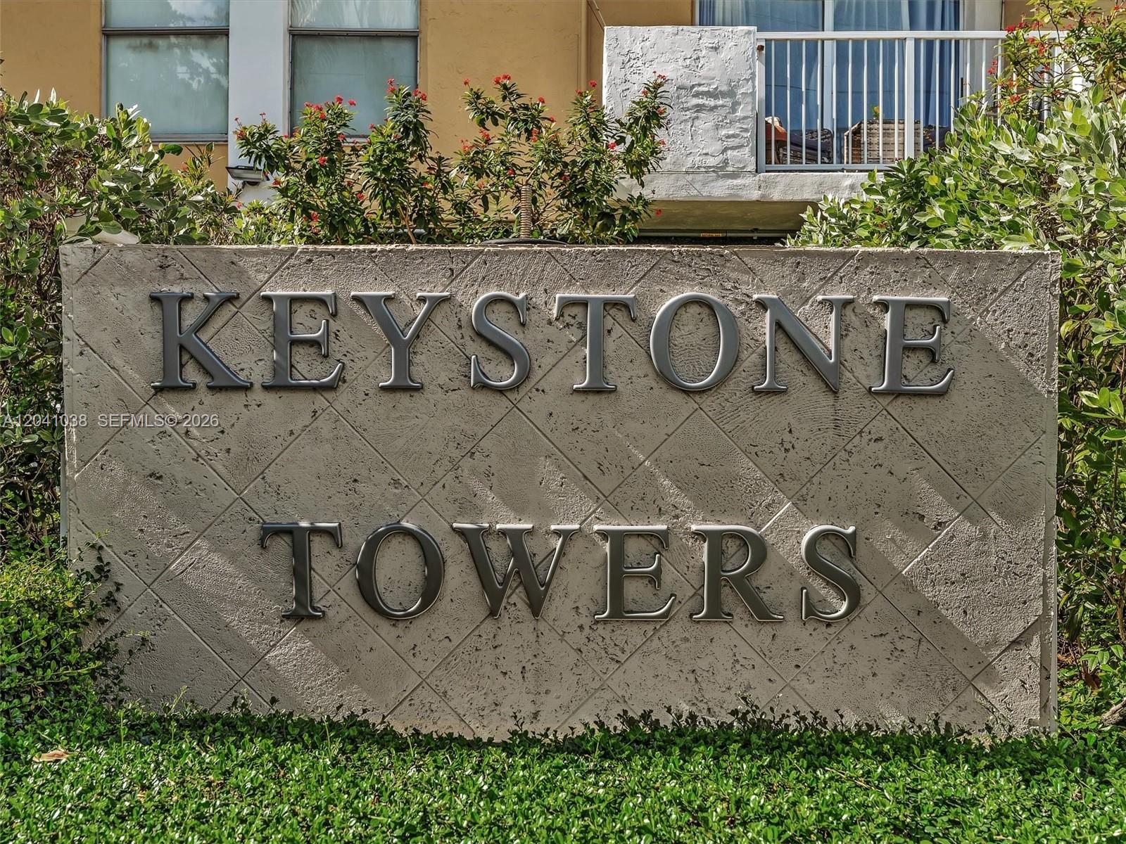 A concrete sign displaying the name Keystone Towers stands in front of a building — 2020 NE 135th St # 601, North Miami FL 33181, NORTH MIAMI, FL
