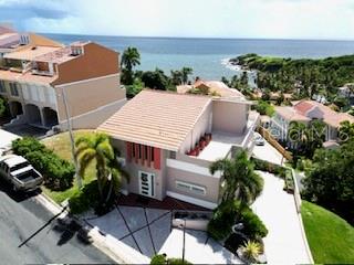 An aerial view of a multi-story house with a tiled roof near the ocean — 1 SHELL CASTLE CLUB UNIT 86, HUMACAO, PR