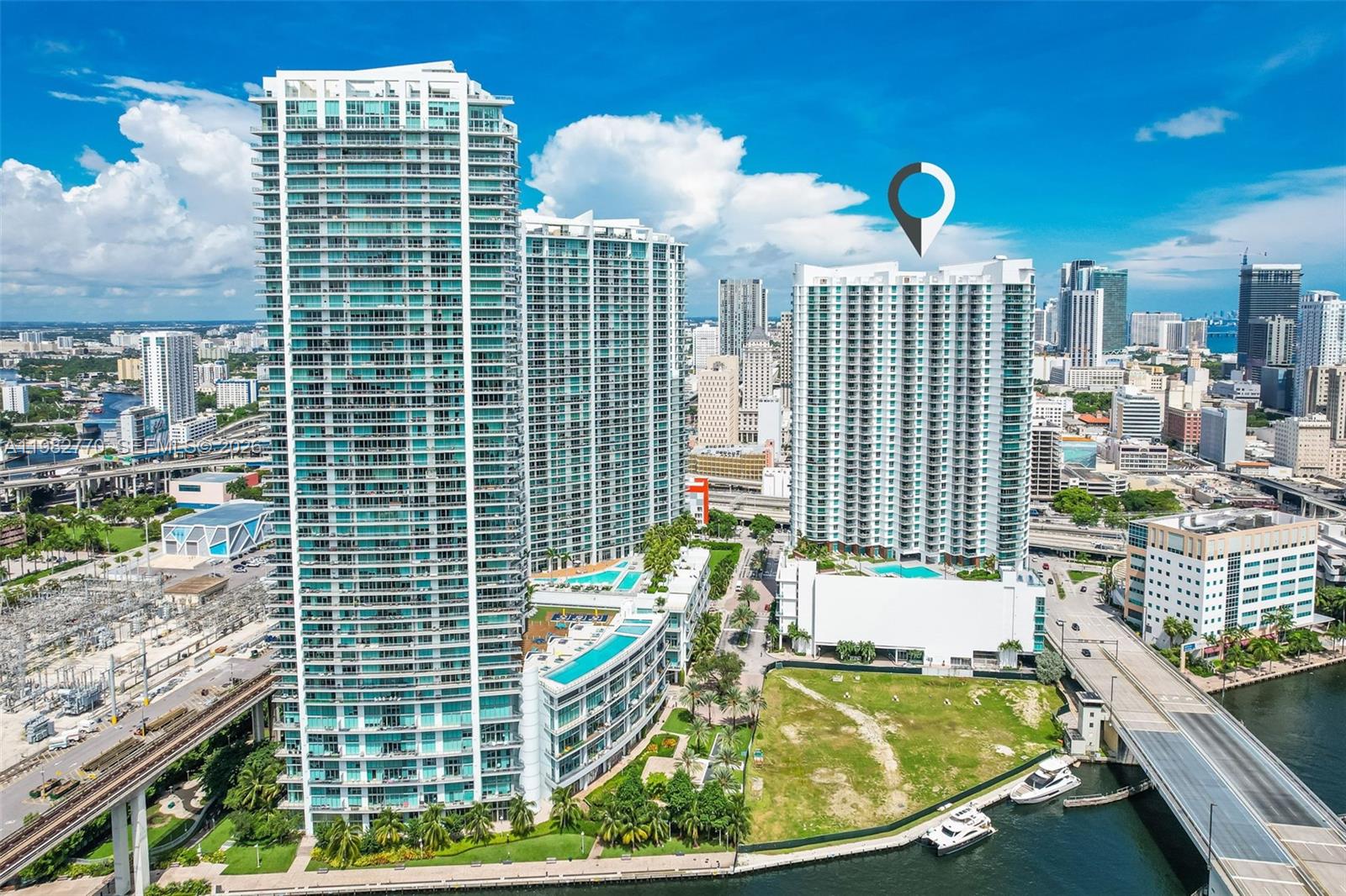 An aerial view of a high-rise residential complex in a dense urban waterfront city — 350 S Miami Ave # 2412, Miami FL 33130, MIAMI, FL